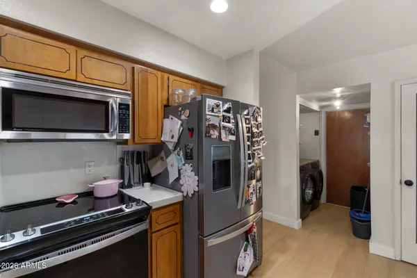 a kitchen with stainless steel appliances granite countertop a refrigerator and a stove top oven