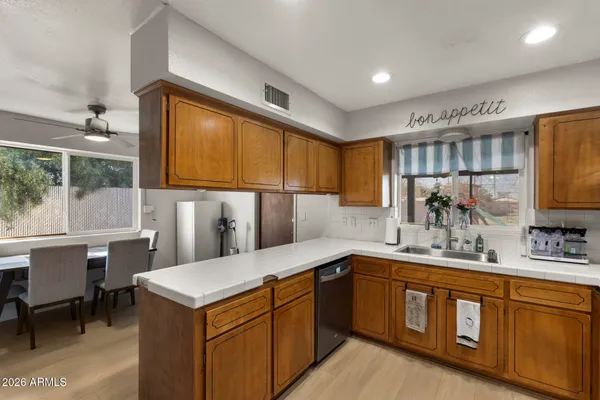 a kitchen with a sink stove and cabinets