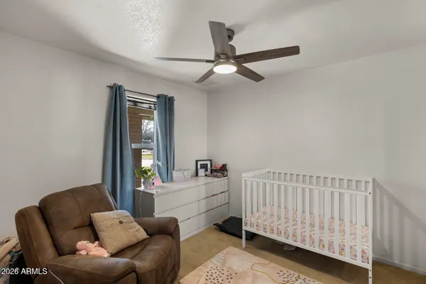 a bedroom with furniture and a ceiling fan
