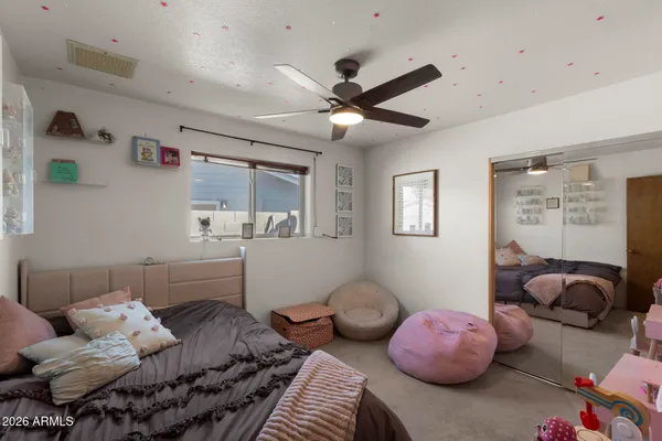 a bedroom with furniture and a gym equipment