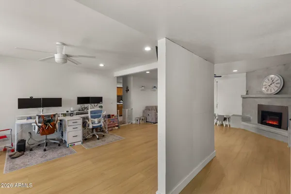 a view of a livingroom with workspace and a window