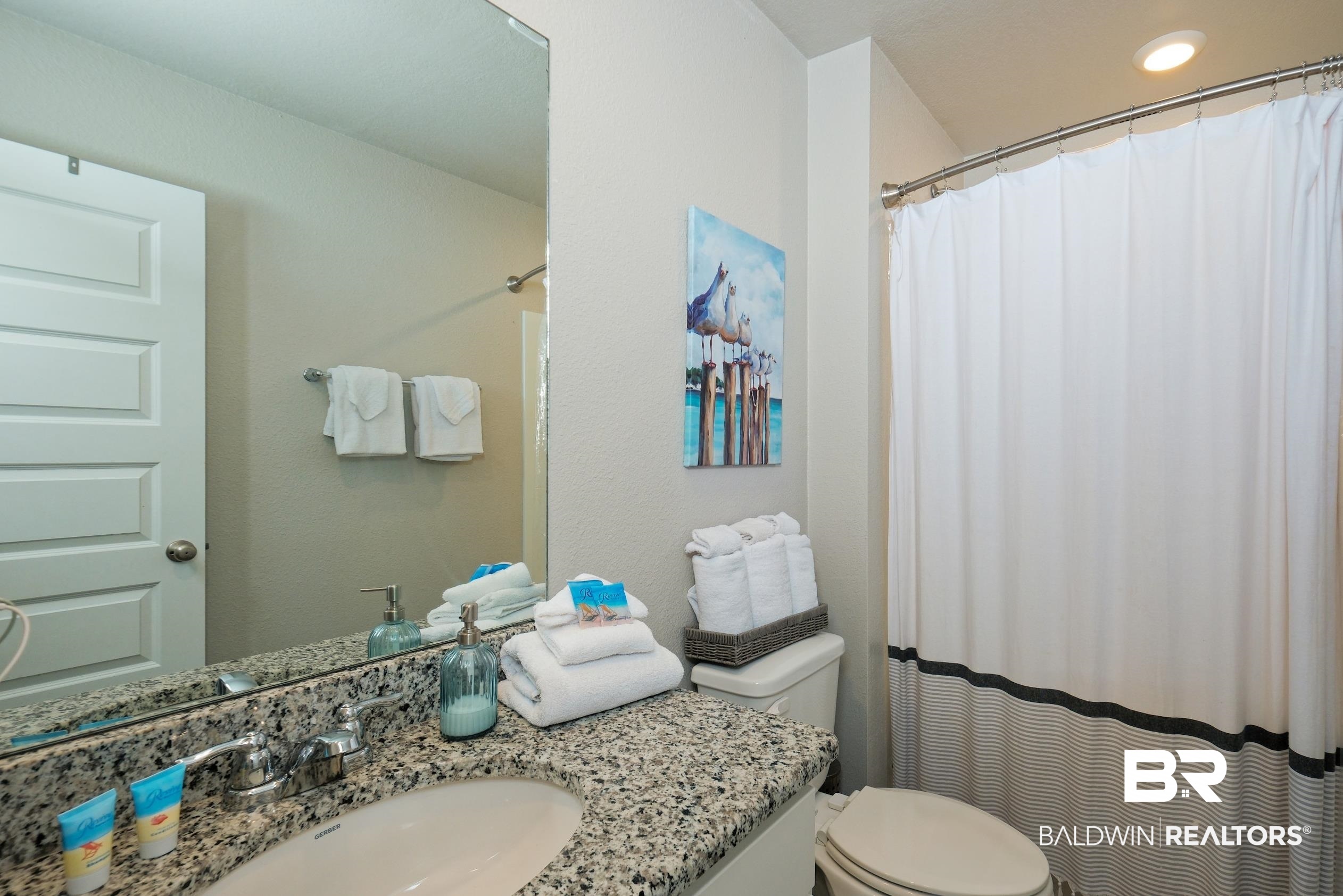 7425 Coppin Drive Foley, AL 36535 - Photo 32 of 41 Bathroom with vanity, curtained shower, and toilet