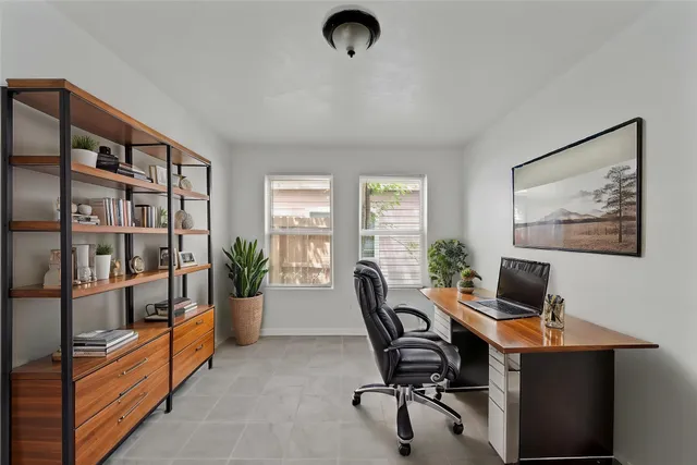 a view of a workspace with a window and lounge chair