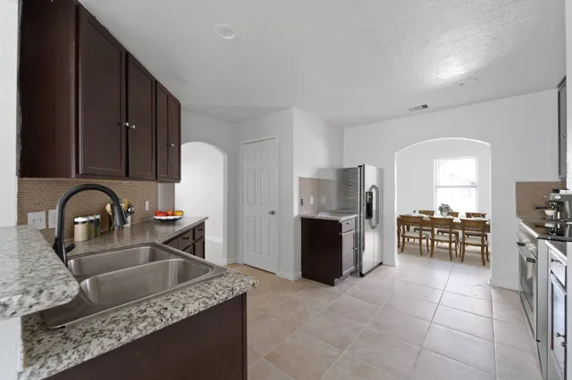 a kitchen with stainless steel appliances granite countertop a stove a sink a microwave and refrigerator