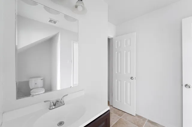 a bathroom with a sink and a large mirror