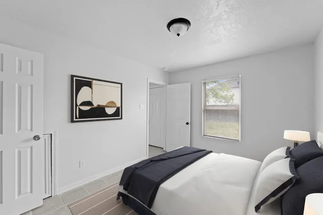 a bedroom with a bed and a window