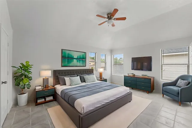 a bedroom with a balcony a bed and a flat screen tv