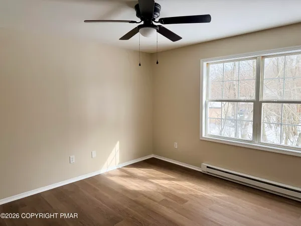 wooden floor in an empty room with a window