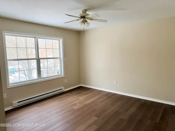 wooden floor in an empty room with a window