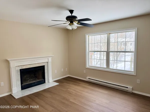 wooden floor in an empty room with a window