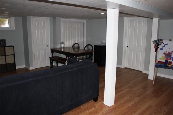 29 Cogger Road Lowell, MA 01854 - Photo 11 of 24 a view of a workspace room with wooden floor windows and a kitchen