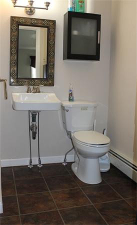 29 Cogger Road Lowell, MA 01854 - Photo 13 of 24 a bathroom with a toilet a sink and mirror