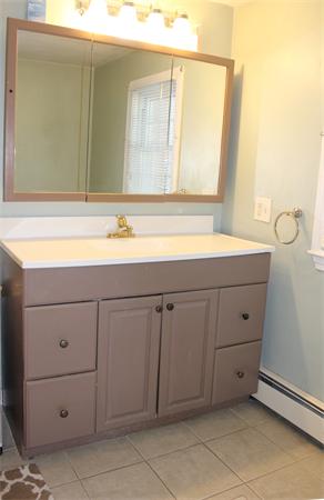 29 Cogger Road Lowell, MA 01854 - Photo 14 of 24 a bathroom with a sink vanity and mirror