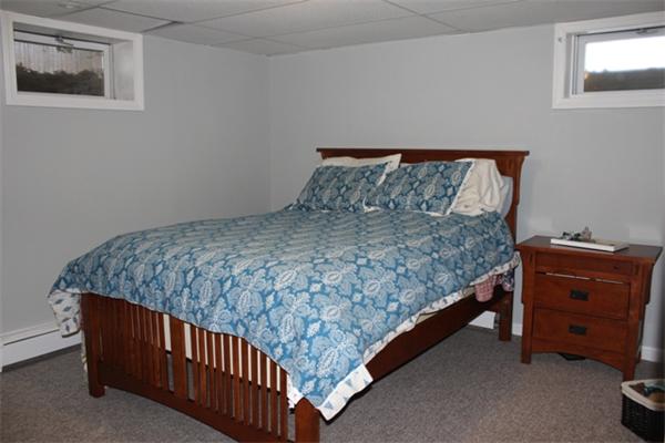 29 Cogger Road Lowell, MA 01854 - Photo 18 of 24 a bed sitting in a bedroom next to a window