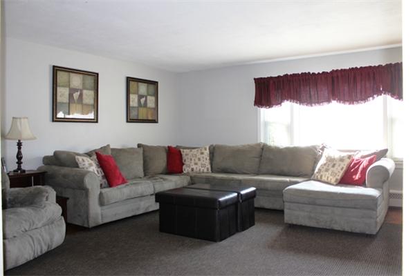 29 Cogger Road Lowell, MA 01854 - Photo 6 of 24 a living room with a couch and a large window