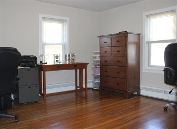 29 Cogger Road Lowell, MA 01854 - Photo 9 of 24 a view of a workspace with wooden floor and furniture