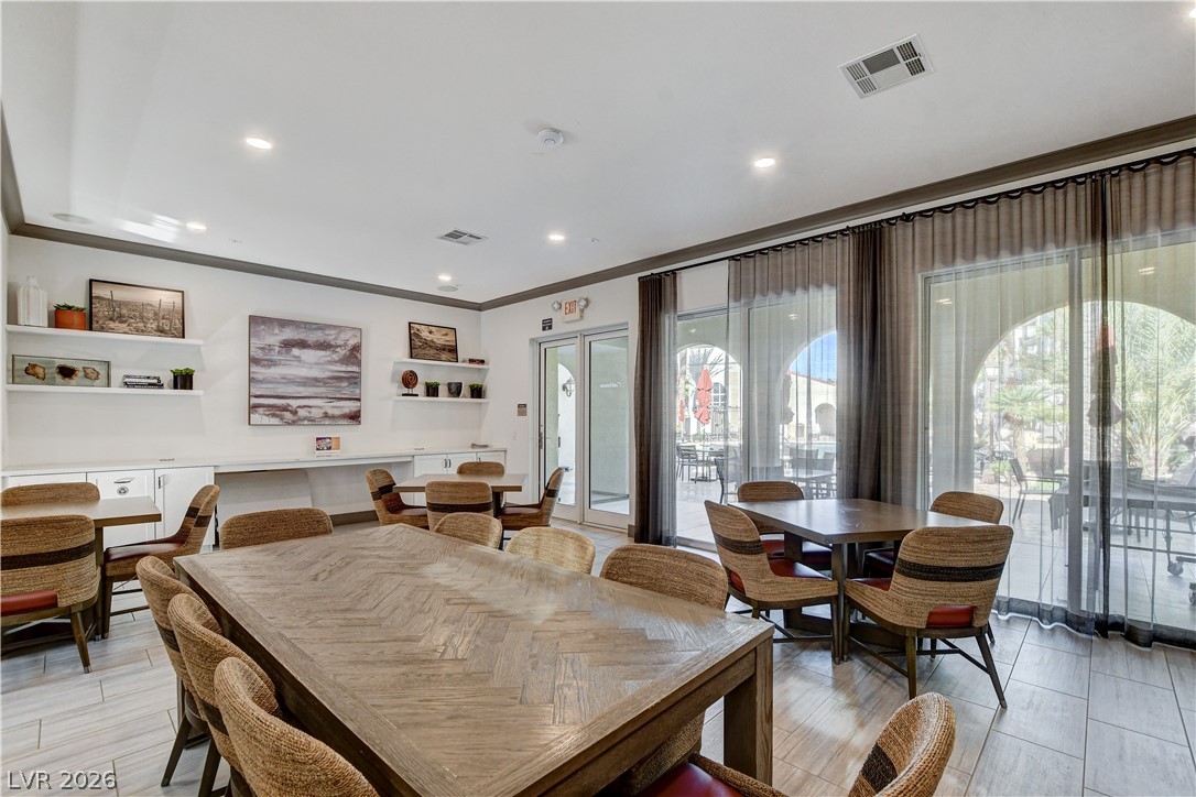 2555 Hampton Road, Unit 2207 Henderson, NV 89052 - Photo 63 of 74 A community gathering space features abundant seating and large sliding doors leading to an outdoor patio.