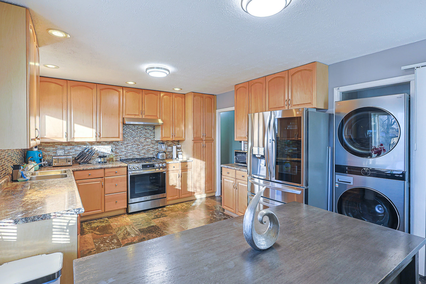 1501 Pawnee Road Carpentersville, IL 60110 - Photo 12 of 22 a kitchen with stainless steel appliances granite countertop a refrigerator a stove top oven a sink and dishwasher