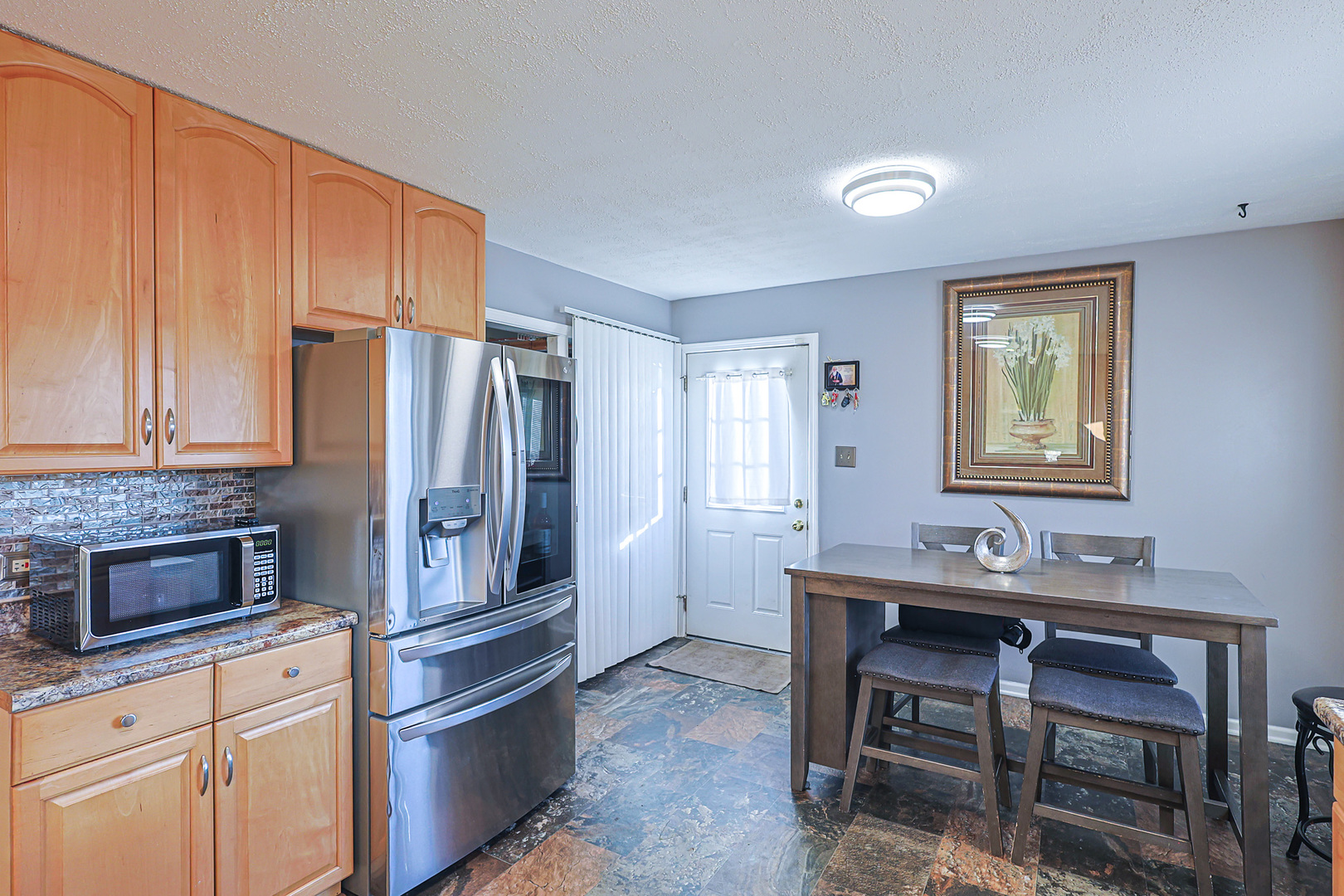 1501 Pawnee Road Carpentersville, IL 60110 - Photo 14 of 22 a kitchen with stainless steel appliances a refrigerator and a stove top oven