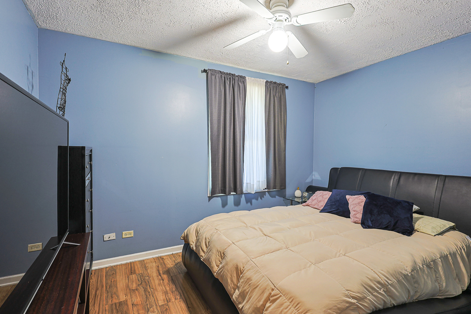 1501 Pawnee Road Carpentersville, IL 60110 - Photo 22 of 22 a bedroom with a bed and a chandelier
