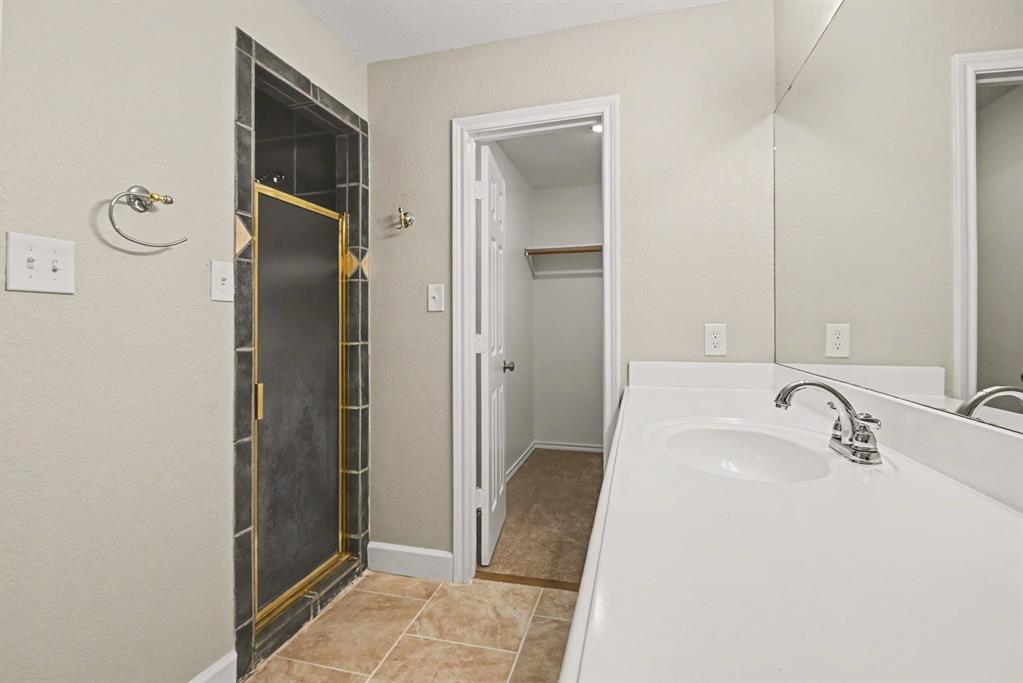 10101 Round Hill Road Fort Worth, TX 76131 - Photo 14 of 30 a bathroom with a sink and a mirror