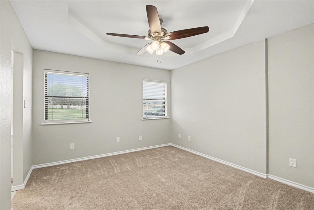 10101 Round Hill Road Fort Worth, TX 76131 - Photo 16 of 30 wooden floor in an empty room with a window