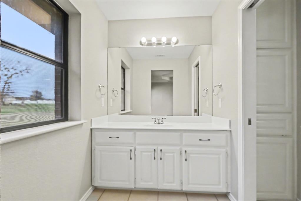 10101 Round Hill Road Fort Worth, TX 76131 - Photo 17 of 30 a bathroom with a sink double vanity and a mirror