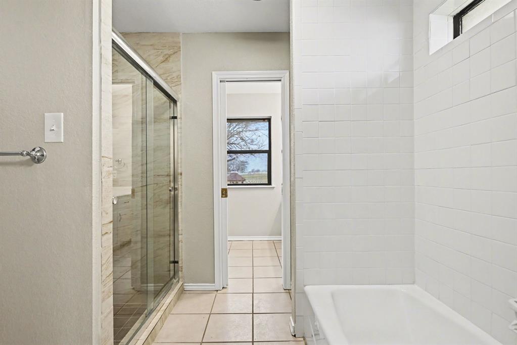 10101 Round Hill Road Fort Worth, TX 76131 - Photo 19 of 30 a bathroom with a shower