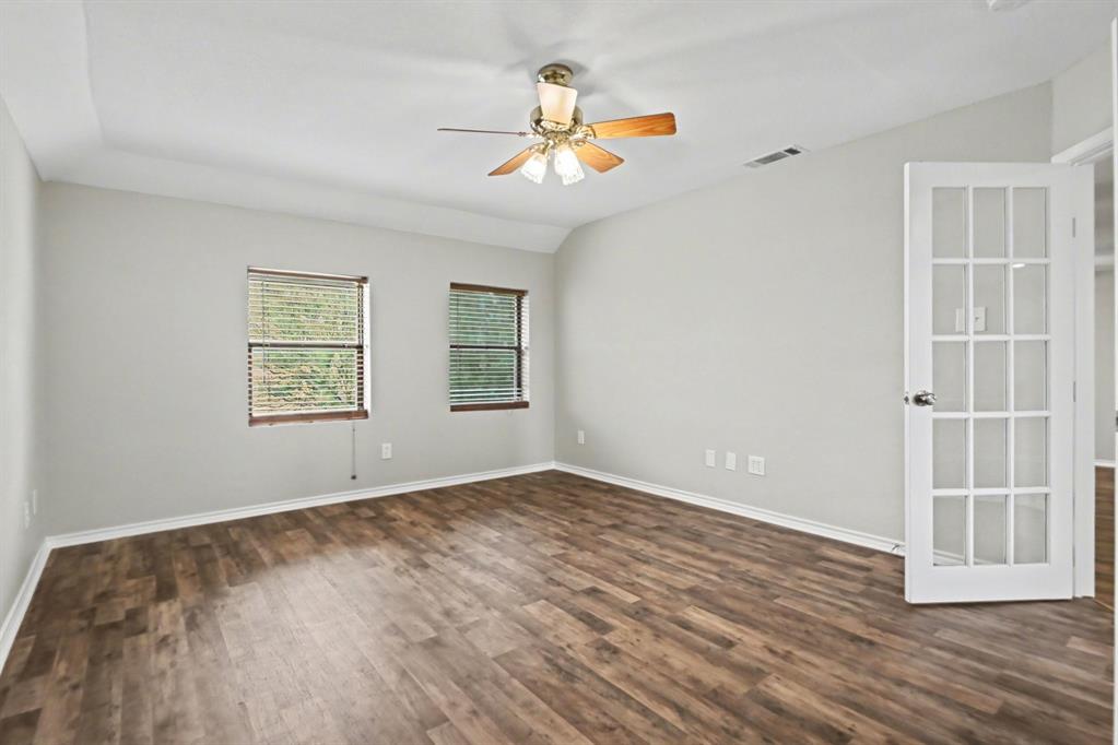 10101 Round Hill Road Fort Worth, TX 76131 - Photo 22 of 30 wooden floor in an empty room with a window