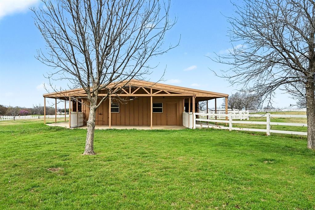 10101 Round Hill Road Fort Worth, TX 76131 - Photo 28 of 30 a front view of a house with a garden