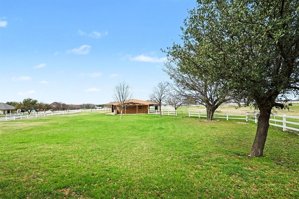 10101 Round Hill Road Fort Worth, TX 76131 - Photo 29 of 30 a backyard of a house with lots of green space