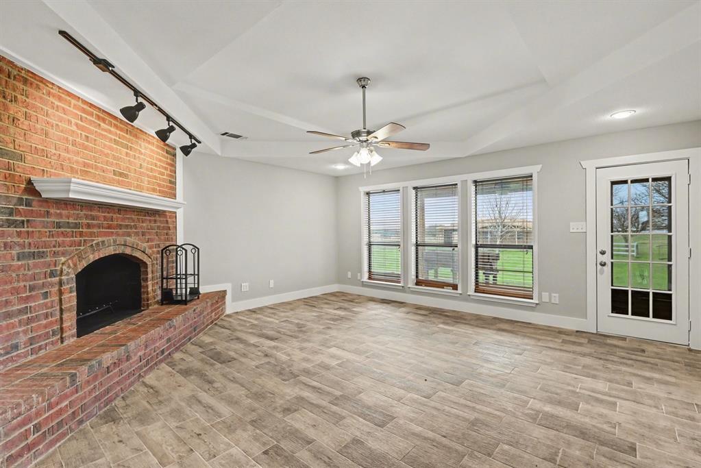 10101 Round Hill Road Fort Worth, TX 76131 - Photo 4 of 30 a view of an empty room with a fireplace and a window