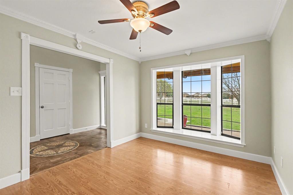 10101 Round Hill Road Fort Worth, TX 76131 - Photo 9 of 30 an empty room with windows and ceiling fan