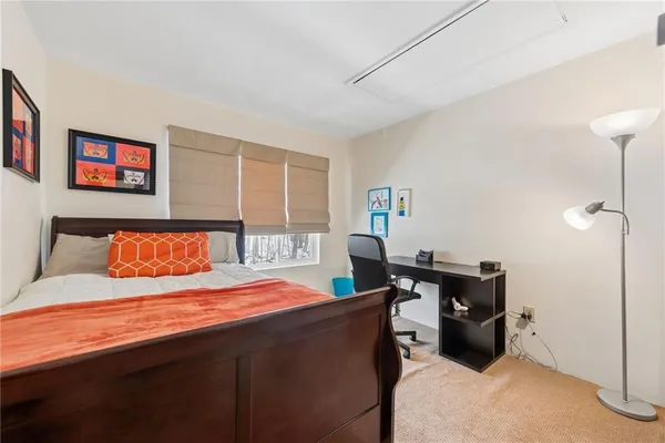 a bedroom with a bed and dresser