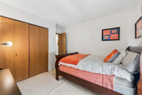 a bed sitting in a bedroom next to a window