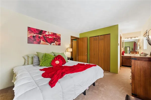 a bedroom with a bed and a view of bathroom