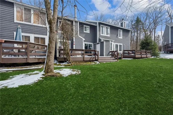 a view of a house with a yard and sitting area