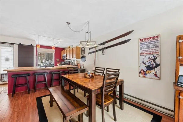 a dining room with a wooden table and chairs