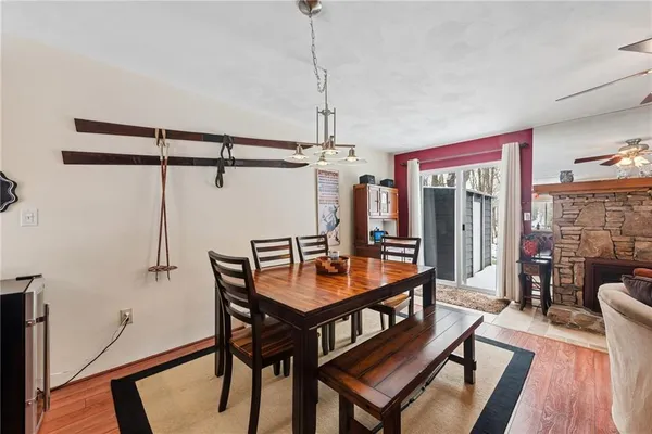 a dining room with furniture and wooden floor