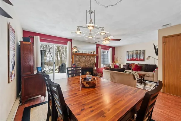 a view of a dining room with furniture a chandelier and wooden floor