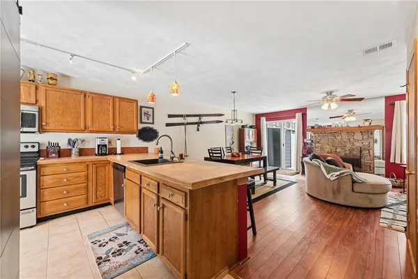 a kitchen with stainless steel appliances kitchen island granite countertop a stove and a refrigerator