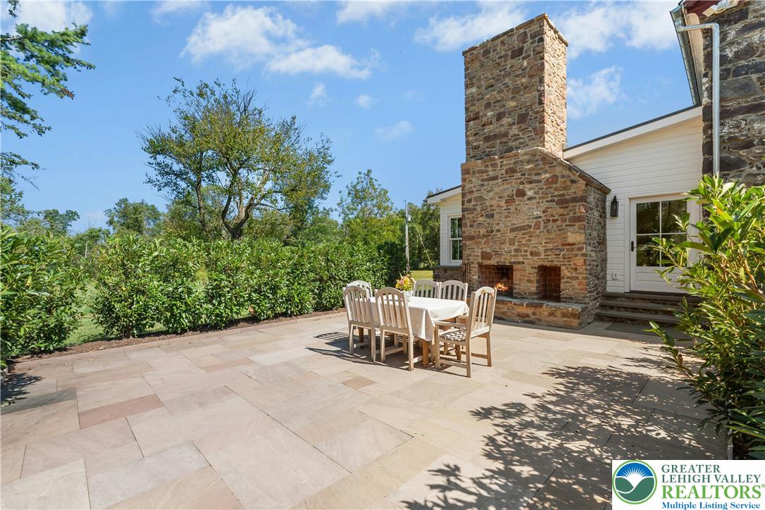 119 Center Hill Road Upper Black Eddy, PA 18972 - Photo 21 of 63 a view of a patio with table and chairs and potted plants