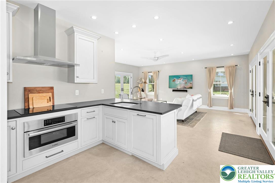 119 Center Hill Road Upper Black Eddy, PA 18972 - Photo 28 of 63 a kitchen with granite countertop a sink and white cabinets