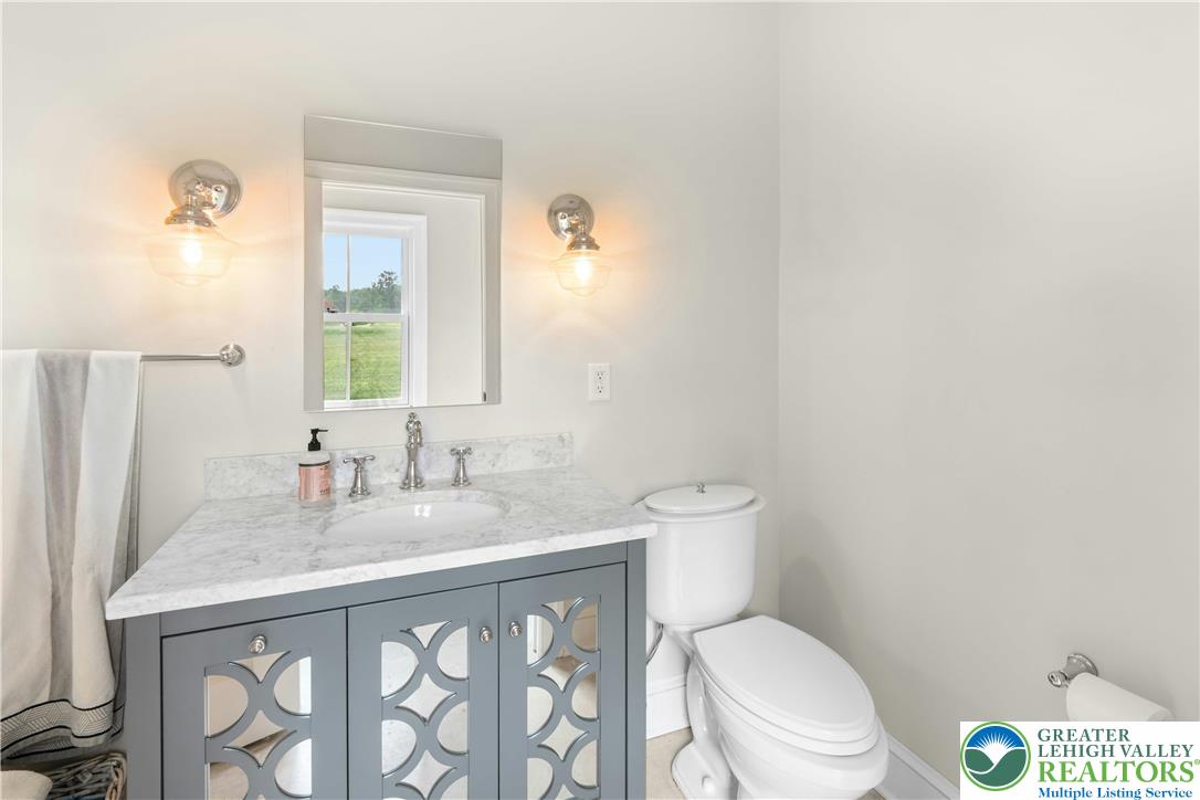 119 Center Hill Road Upper Black Eddy, PA 18972 - Photo 30 of 63 a bathroom with a granite countertop toilet sink and mirror