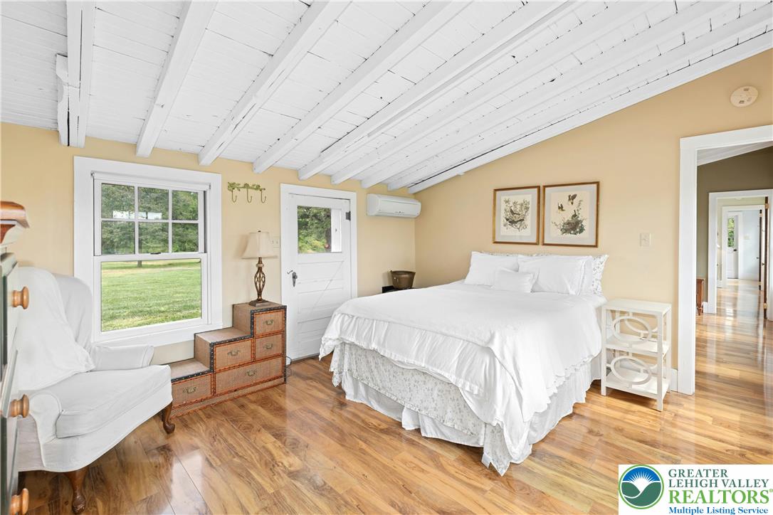 119 Center Hill Road Upper Black Eddy, PA 18972 - Photo 50 of 63 a spacious bedroom with a bed couch and a large window