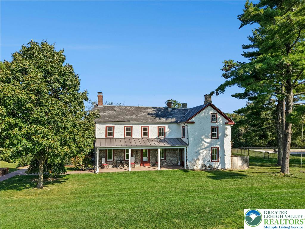 119 Center Hill Road Upper Black Eddy, PA 18972 - Photo 5 of 63 a front view of a house with a garden