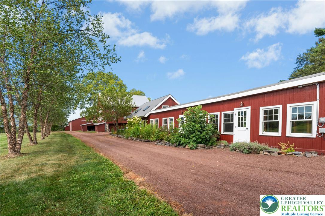 119 Center Hill Road Upper Black Eddy, PA 18972 - Photo 56 of 63 a front view of a house with a yard and trees