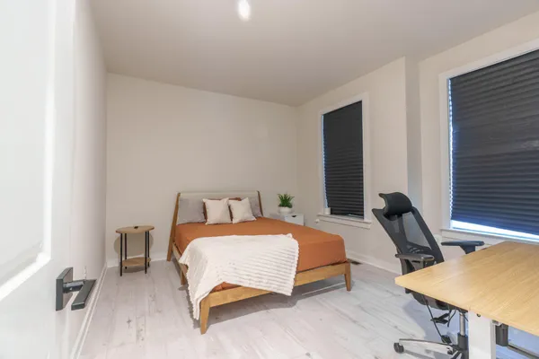 a bedroom with a bed and a desk