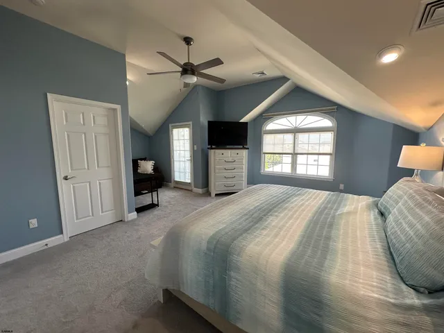 a bedroom with a large bed and a window