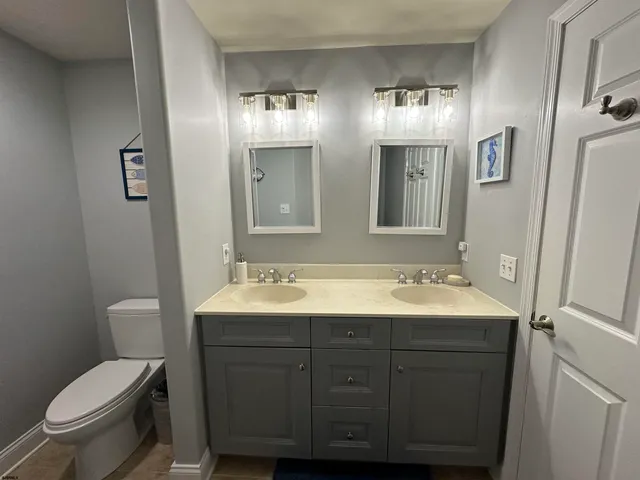a bathroom with a toilet sink and mirror